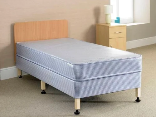 A bed with a wooden heardboard, six legs and a blue mattress.
