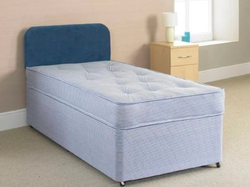 A divan bed with a blue mattress and headboard.